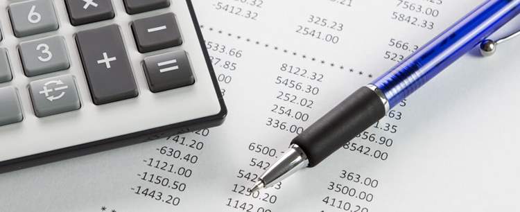 An image of a calculator and balance sheet