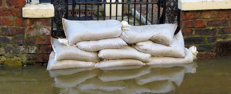 Bags on a flood showing What Is Flood Insurance