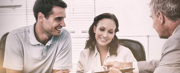 Couple speaking to an home insurance type advisor