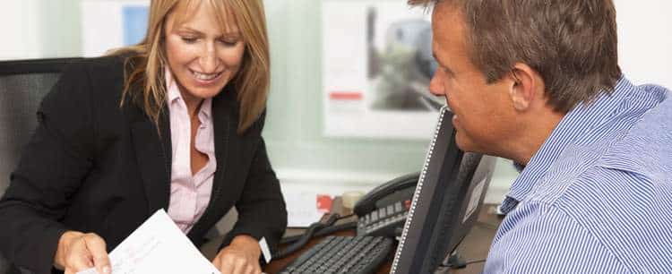 Man speaking to a woman about buy to let lending