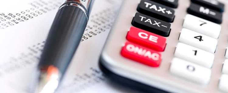 Calculator pictured next to a pen