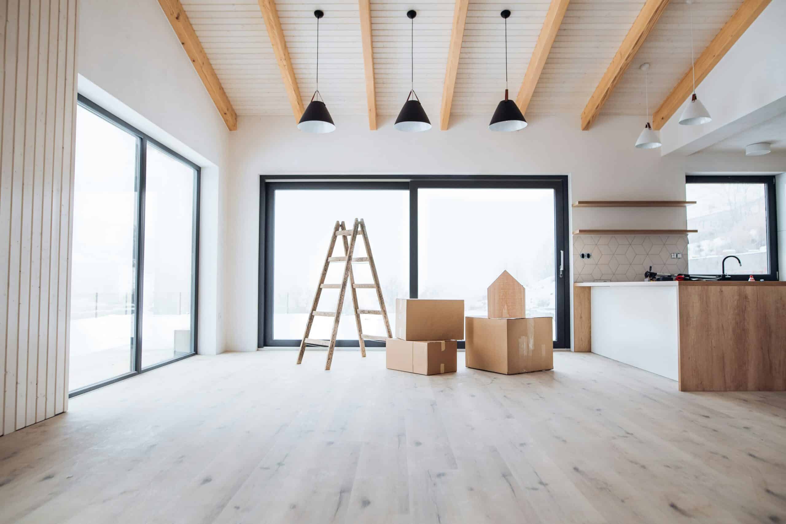 An empty room with boxes and ladder