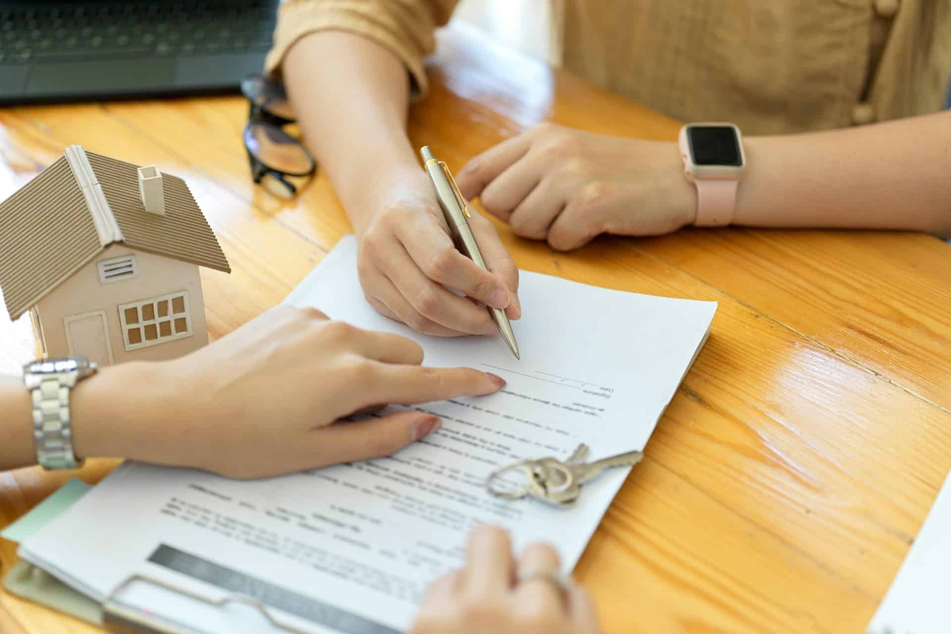 A solicitor and their client discussing what landlord insurance is and whether or not they need it